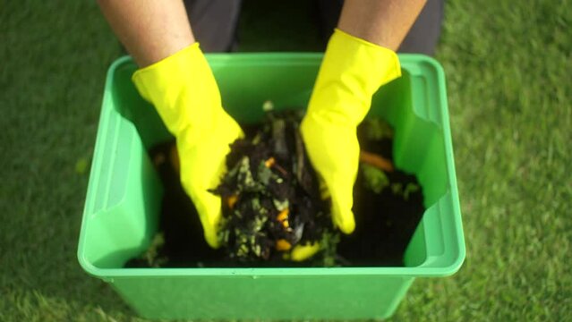 
Composting and composted soil from kitchen ,food waste, fruit vegetable peels and egg shell rotting into organic fertilizer recycle composter environmentally friendly. Reduce zero waste concept.