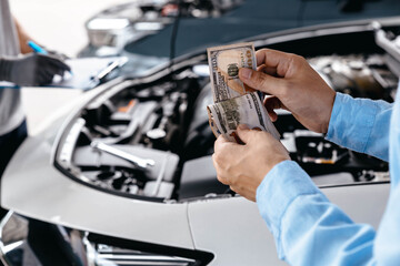 Customer pay with money for repair to the mechanic at garage workshop, Spending and car financial...