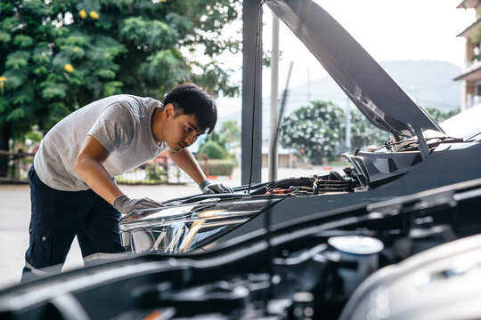 Mechanic technical check of auto at garage workshop, Car auto services and maintenance check concept.