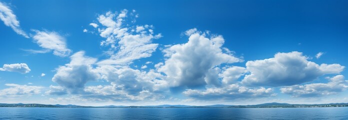 Scenic blue sky adorned with fluffy white clouds, a serene natural panorama