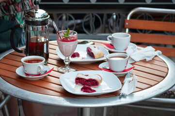 delicious dessert Cherry strudel on a table in a street cafe with fruit milkshake, stylish table setting, High quality photo