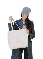 Woman holding white textile tote eco bag. White eco bag for mock up. - 659899268