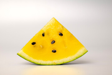 Fresh yellow watermelon slice on background, juicy delicious cut watermelon with a yellow core