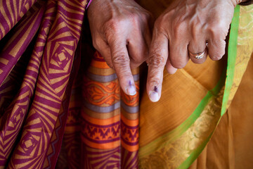 Old indian women showing the ink mark on their fingers after voting, Karnataka, India