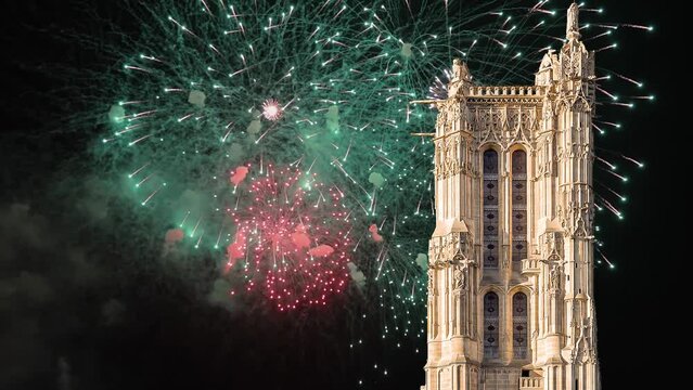 Celebratory colorful fireworks over the Saint-Jacques Tower (Tour Saint-Jacques). Located on Rivoli street, Paris, France. This 52 m Flamboyant Gothic tower (XVI century).  4K, time lapse