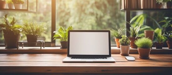 Computer screen mockup with a blank white screen on a wooden desk office background and room for text