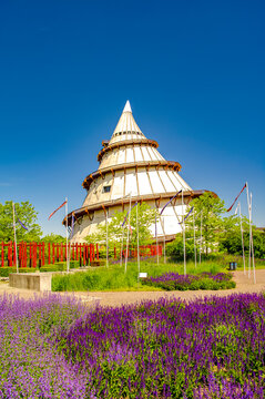 Magdeburg, Germany. Cover page with Japanese garden and science and technology exhibition tower as a cone in the Elbauen city park. Cityscape in the historical downtown