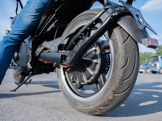 Close-up of the rear wheel with the engine of an electric motorcycle.