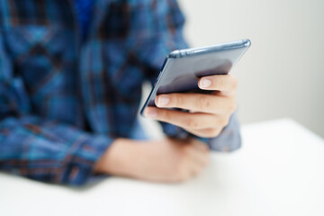 Asian teenage using mobile application in digital smartphone technology for learning.