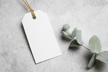 Blank white price tag mockup on grey background, gift tag or paper label with copy space