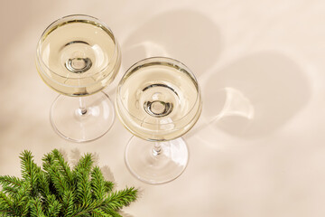 Two champagne glasses on a beige