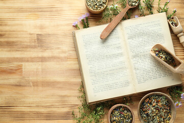 Book, herbs in bowls and scoops on wooden background, space for text