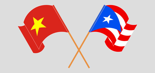 Crossed and waving flags of Vietnam and Puerto Rico