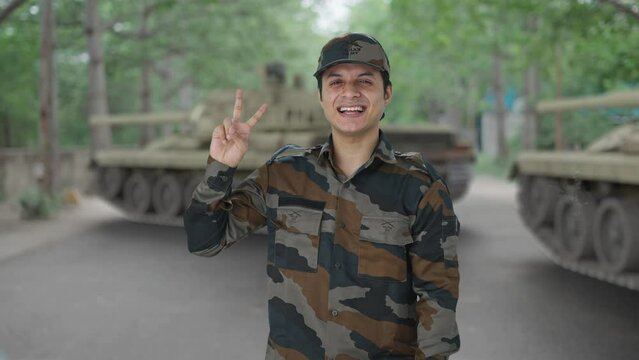 Happy Indian army man showing victory sign