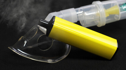 Electronic cigarette and inhalation mask on black background