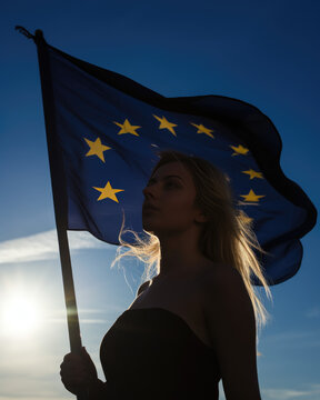 a young woman holds a flag of Europe during a commemoration for peace