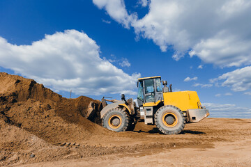 Yellow Excavator working on sand industrial quarry. Construction site industry concept