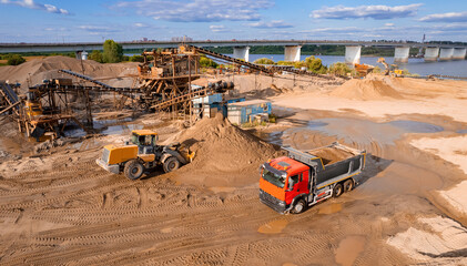 Mining conveyor, excavator and truck working in sand opencast, aerial top view. Open pit mine...