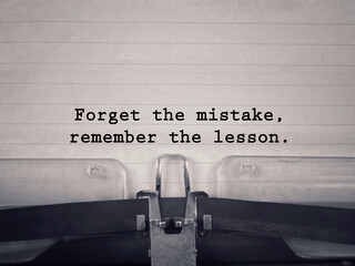 Motivational and inspirational wording. Forget The Mistake, Remember The Lesson written on a paper....