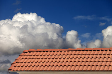 Roof tiles and blue sky with clouds - 659941028