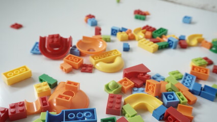 Plastic building blocks on a white background, close-up.