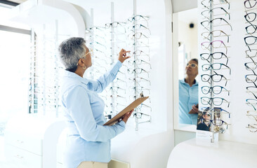 Glasses, eye care or senior woman with retail in store for checklist stock, inventory or eyewear choice. Vision, ophthalmology or optician in frame clinic with clipboard for product in optometry shop