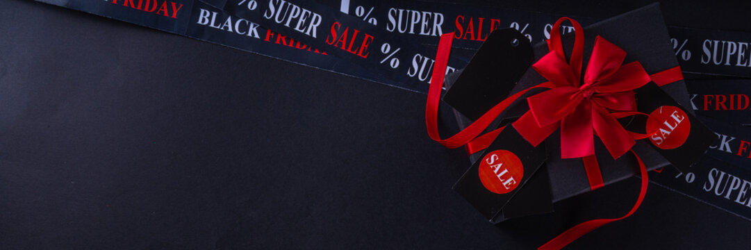Black friday shopping and day background, Black Friday advertisement, sale promotion invitation with black red gift boxes, laptop, shop tags, crossed sale ribbons, copy space