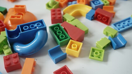 Plastic building blocks on a white background, close-up.