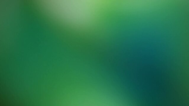 Smooth transitions of green light on a black screen. Stock abstract background with emerald glow in 4K. Long video for flash overlay.