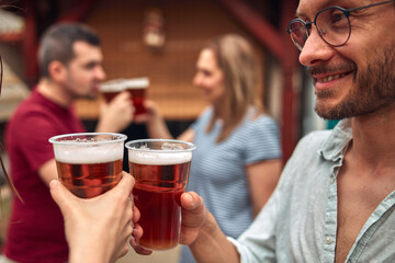 Group of friends enjoying cold beer at a backyard party.