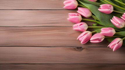 Pink tulip bouquet on retro wooden background