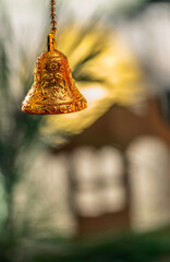 A golden bell hung on Christmas tree / Merry Christmas