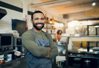 Happy man, portrait and small business owner in kitchen at restaurant for hospitality service, cooking or food. Face of male person, employee or waiter smile in confidence for professional culinary - Powered by Adobe