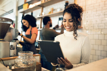 Happy woman, tablet and small business at cafe in management, network or ownership at coffee shop. Female person, entrepreneur or restaurant owner smile with technology, team and barista in store