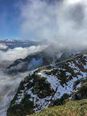 Mountain landscape with clouds and fog on the top of the hill