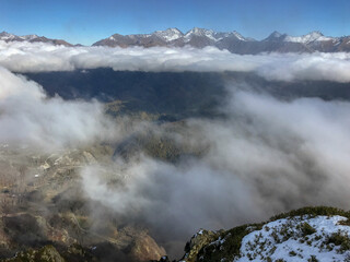 Mountain landscape with clouds and fog on the top of the hill