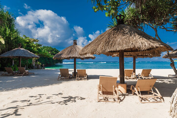 Chairs and umbrella at beach with palms. Holiday banner of luxury resort