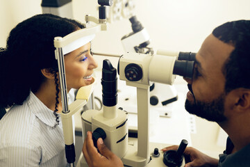 Eye test, machine and a woman with a doctor for optometry, vision problem and surgery on lens. Happy, clinic and a patient with a man or optometrist for a medical exam, retina health and check