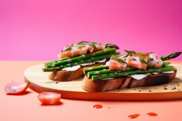 bruschetta with asparagus on a pink backdrop