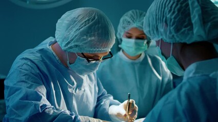 A male surgeon is using a tweezer to operate on his patient while being in a surgical room and getting help from his two assistants - Powered by Adobe