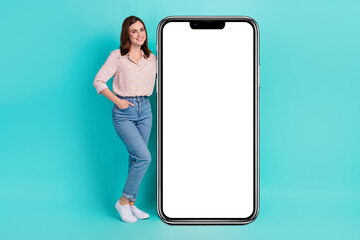 Full length photo of pretty cute girl dressed pink shirt holding modern device empty space isolated teal color background