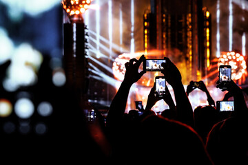 Taking photo or video content for social networks at the concert, Mobile phone on music show. - obrazy, fototapety, plakaty