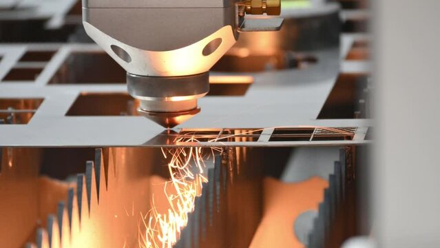 The fiber laser cutting machine  cut the metal plate with the sparkling light.