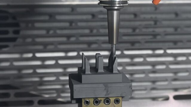 The CNC milling machine cutting the graphite electrode parts.