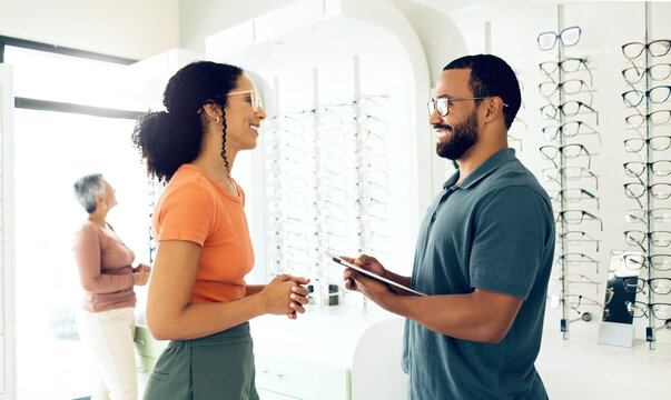 Optometry, glasses choice and tablet with inventory list in store, health with communication and vision. Service, help and trust with advice, eye care consultation with man and woman in clinic