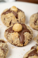 Hazelnut cookies. Chocolate and hazelnut cookies on a white wooden background. patisserie products. Close up