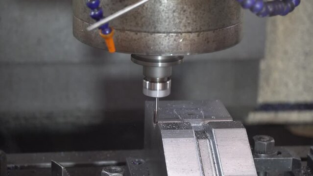 The CNC milling machine cutting press die part by solid bull end mill tool and G-code data background.