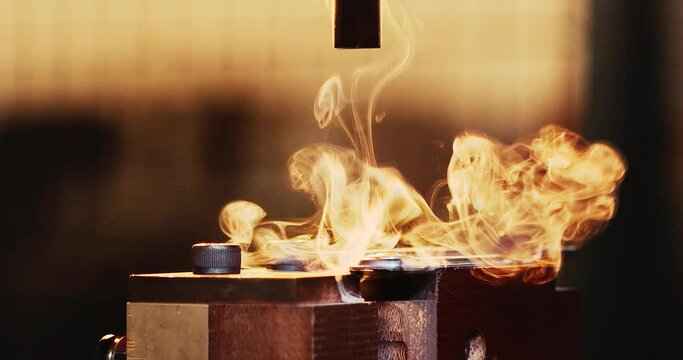 CNC milling machine to cut mold parts with burning sawdust. Mold and die manufacturing process.