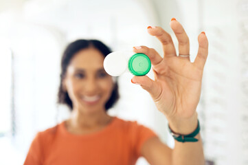 Hand, vision and contact lens container with a person at the optometrist for eye care or health...