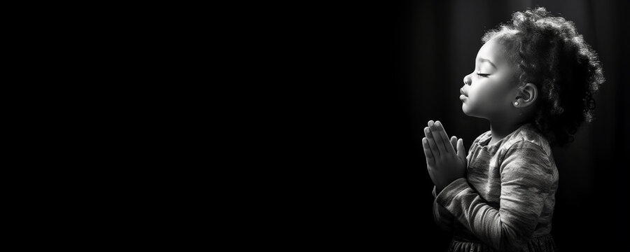 Black and white portrait banner of an African girl praying